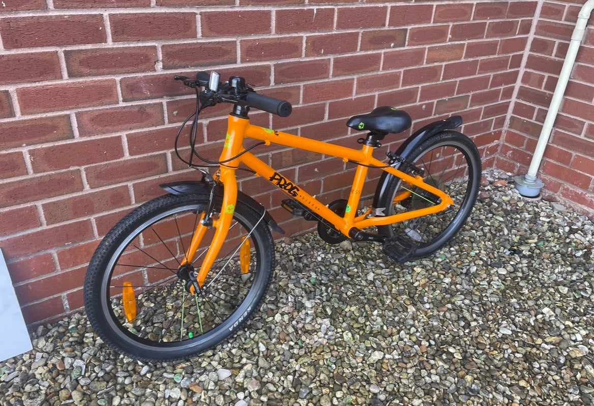 A Pre Loved Frog Bike For Sale, Orange Frog 55 Hybrid bicycle, 20” wheels, 8 speed, V brakes, mudguards, nationwide delivery is available.