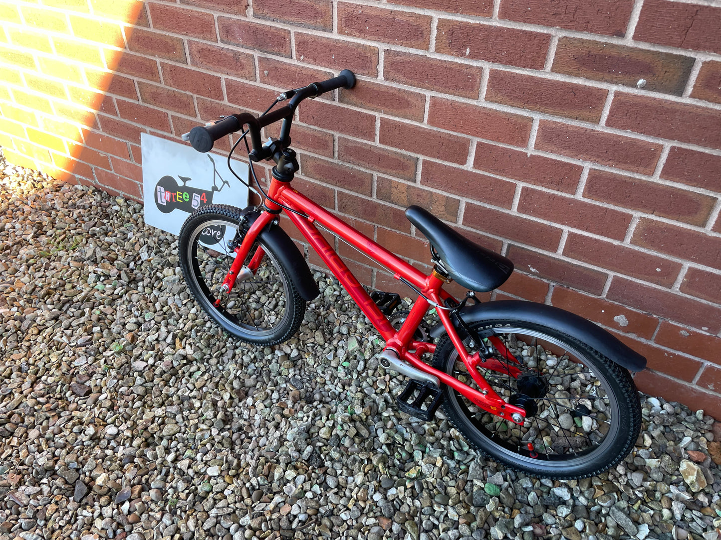 A Pre Loved Isla Bike For Sale, Red Isla Cnoc 16 First Pedal Bike, 16” wheels, V brakes, mudguards, very lightweight, nationwide delivery is available.