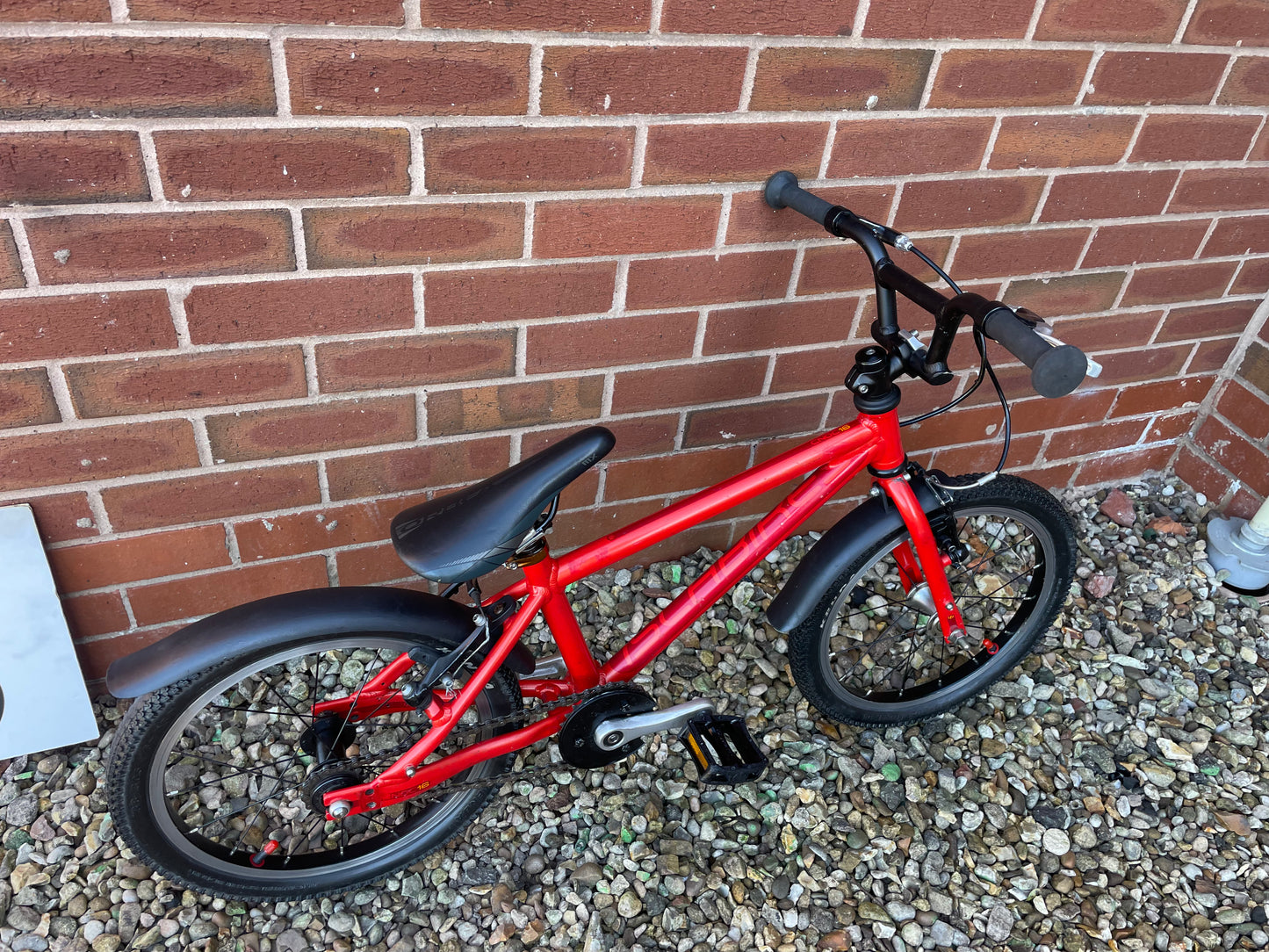 A Pre Loved Isla Bike For Sale, Red Isla Cnoc 16 First Pedal Bike, 16” wheels, V brakes, mudguards, very lightweight, nationwide delivery is available.