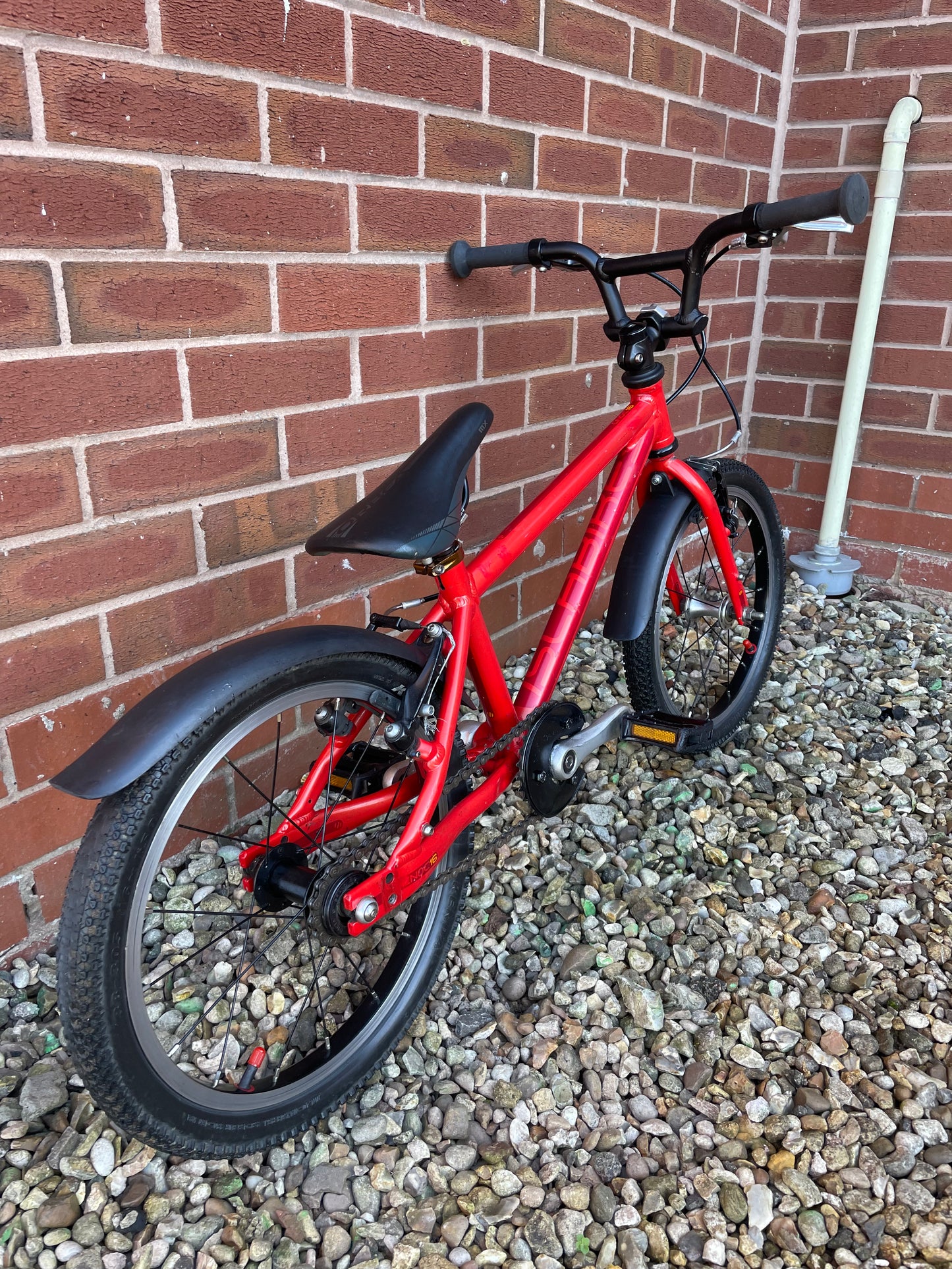 A Pre Loved Isla Bike For Sale, Red Isla Cnoc 16 First Pedal Bike, 16” wheels, V brakes, mudguards, very lightweight, nationwide delivery is available.