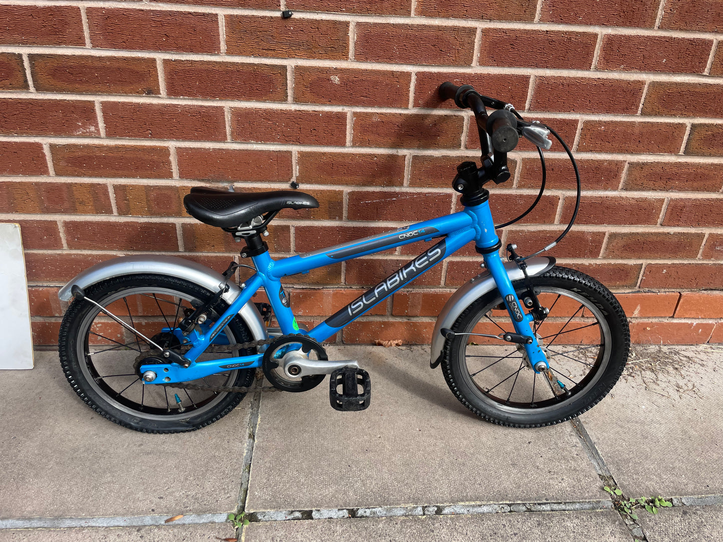 A Pre Loved Isla Cnoc 14 first pedal bike For Sale, Blue, 14” wheels, V brakes, mudguards, very lightweight, nationwide delivery is available.
