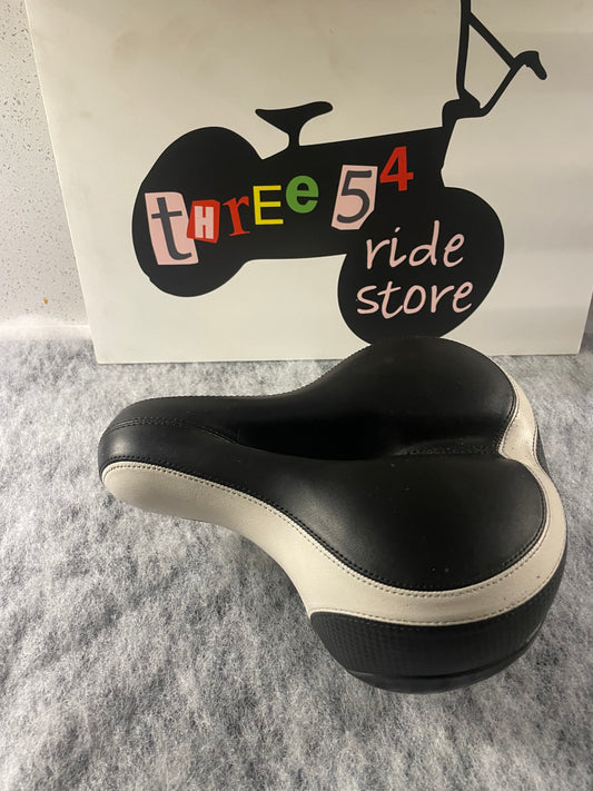 Brand new wide and sprung bicycle seat for sale, black and white, built in reflector.