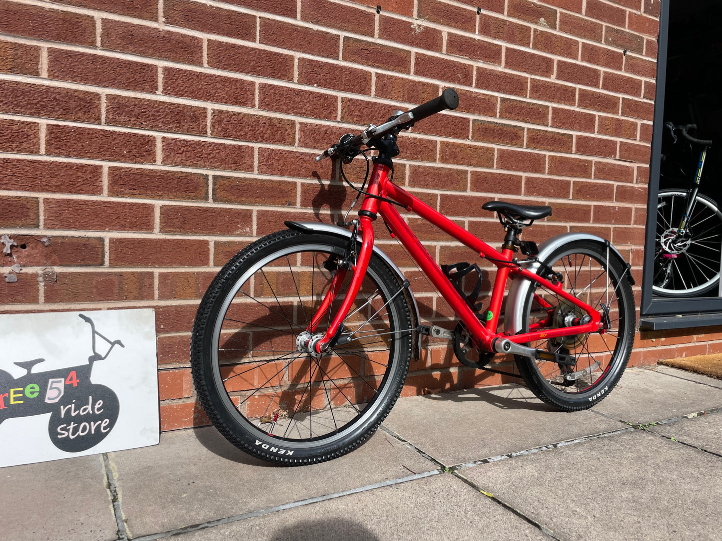 A Pre Loved Isla Bike For Sale, Red Isla Beinn 20s, 20” wheels, 8 speed, mudguards, bottle cage, very lightweight children’s bike, nationwide delivery is available.