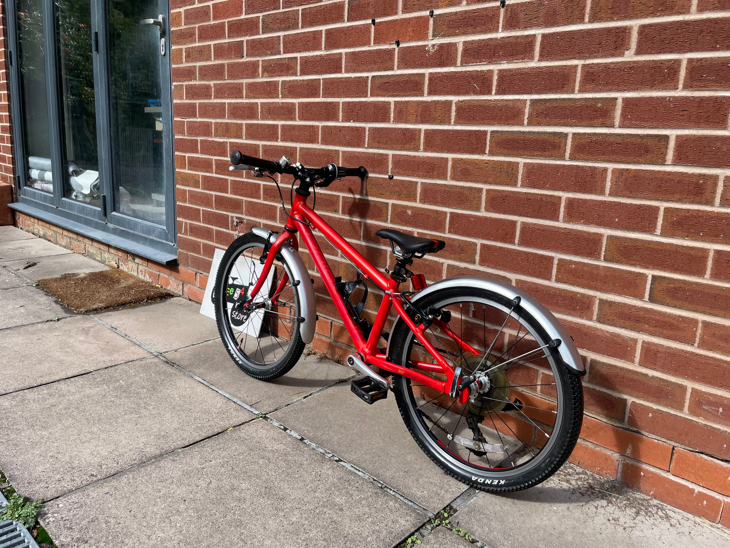 A Pre Loved Isla Bike For Sale, Red Isla Beinn 20s, 20” wheels, 8 speed, mudguards, bottle cage, very lightweight children’s bike, nationwide delivery is available.