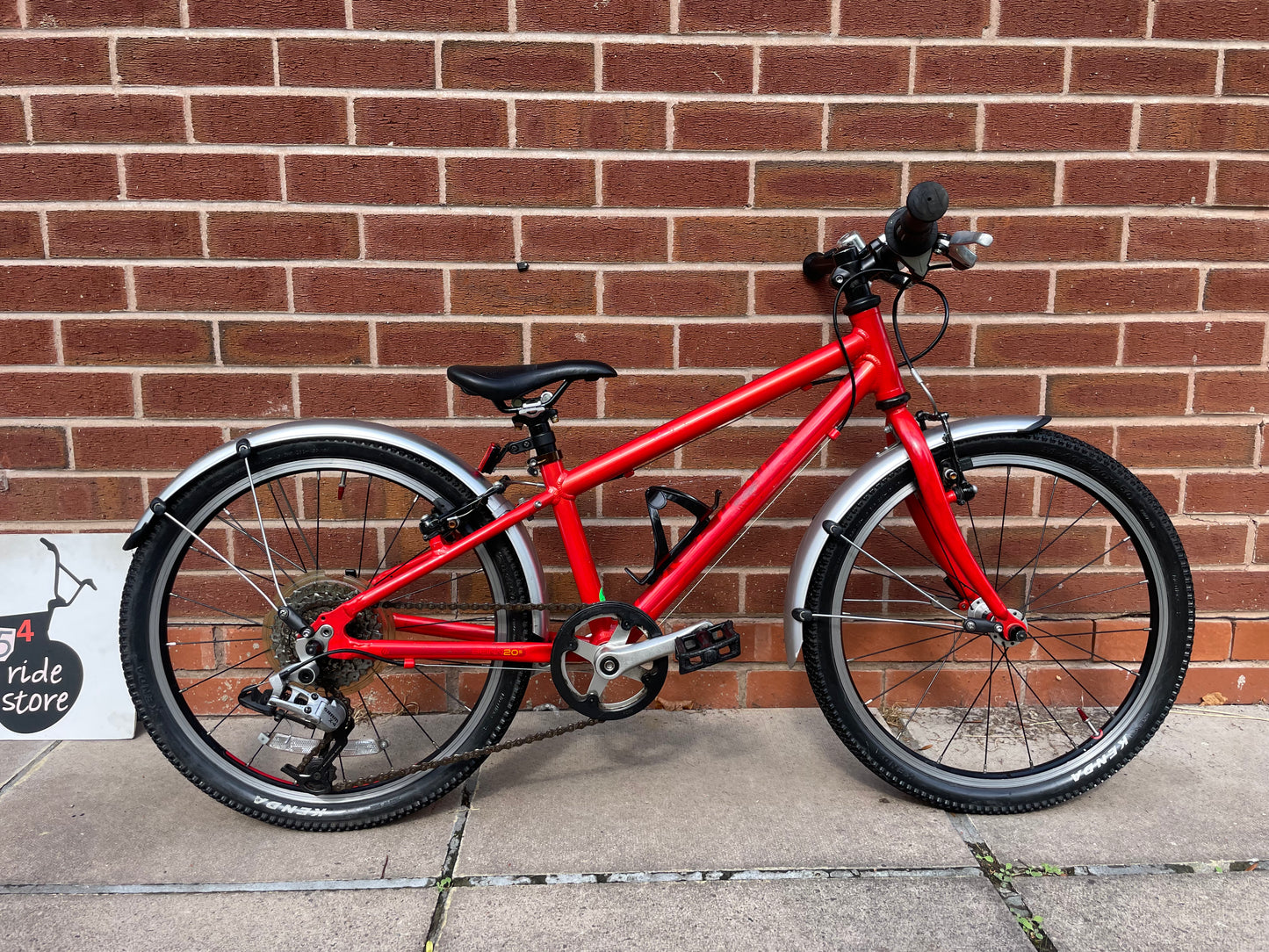 A Pre Loved Isla Bike For Sale, Red Isla Beinn 20s, 20” wheels, 8 speed, mudguards, bottle cage, very lightweight children’s bike, nationwide delivery is available.