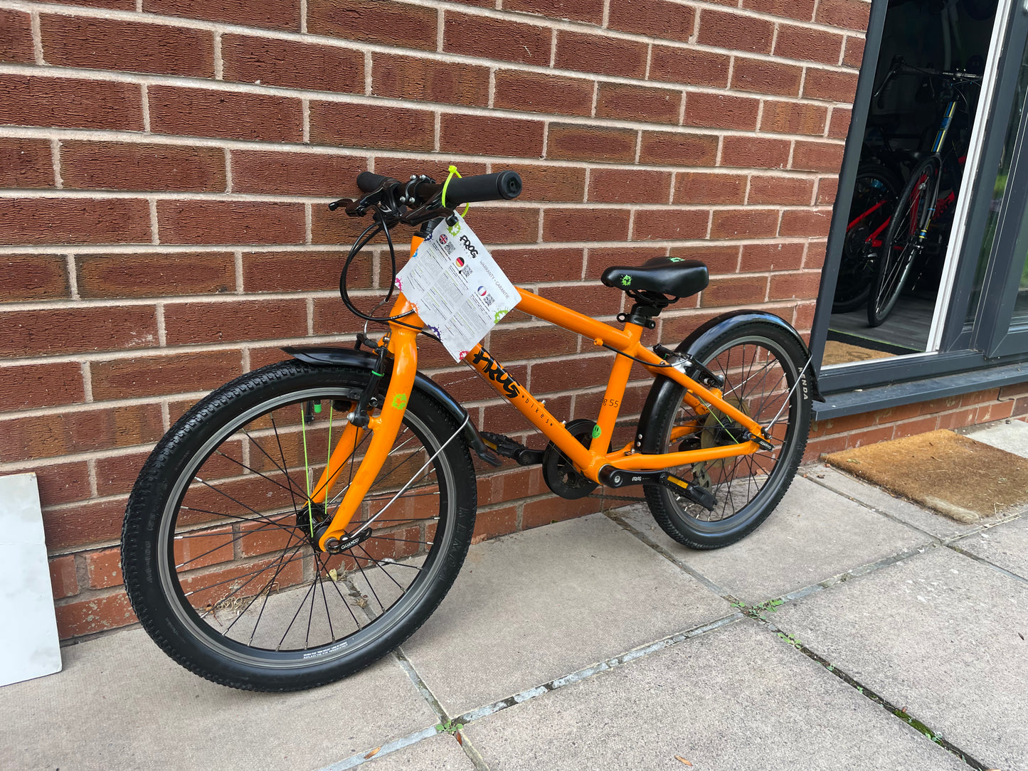 A Pre Loved Frog Bike For Sale, Orange Frog 55, lightweight children’s bicycle, 20” wheels, 8 speed, V brakes, mudguards, nationwide delivery is available.