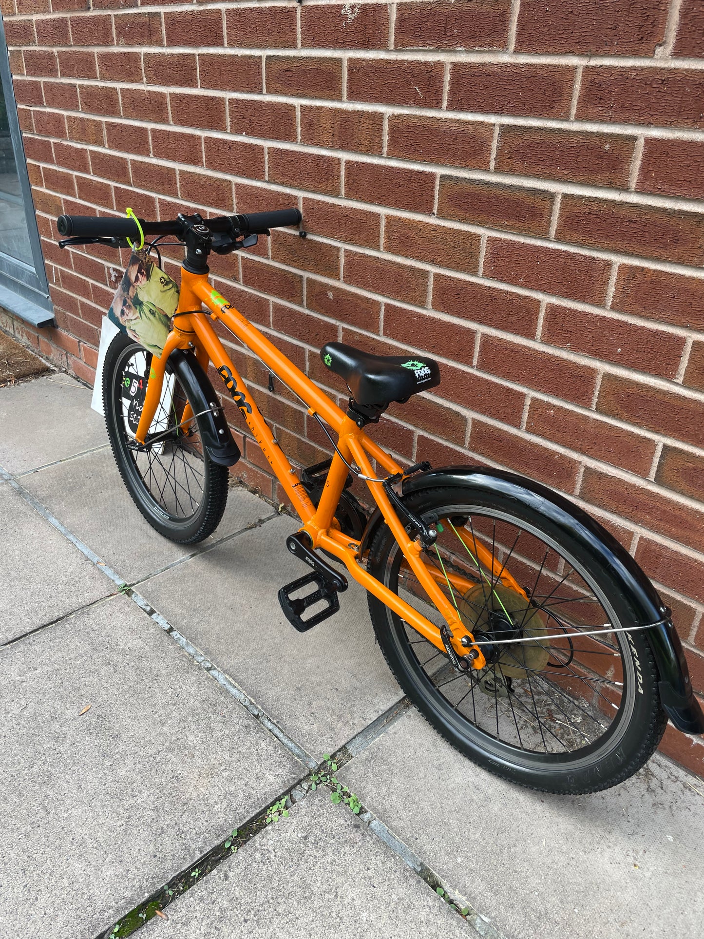 A Pre Loved Frog Bike For Sale, Orange Frog 55, lightweight children’s bicycle, 20” wheels, 8 speed, V brakes, mudguards, nationwide delivery is available.