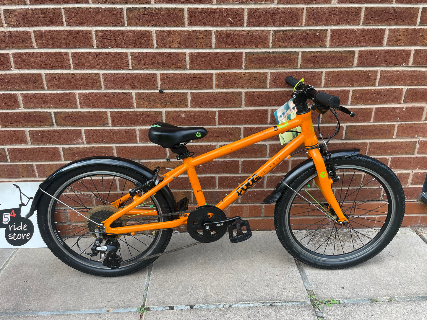 A Pre Loved Frog Bike For Sale, Orange Frog 55, lightweight children’s bicycle, 20” wheels, 8 speed, V brakes, mudguards, nationwide delivery is available.