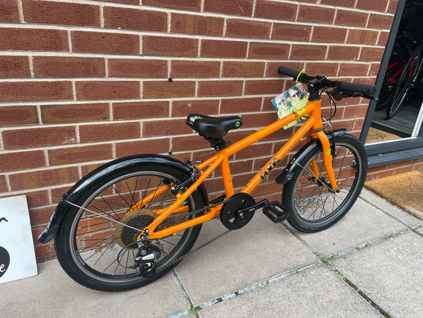 A Pre Loved Frog Bike For Sale, Orange Frog 55, lightweight children’s bicycle, 20” wheels, 8 speed, V brakes, mudguards, nationwide delivery is available.