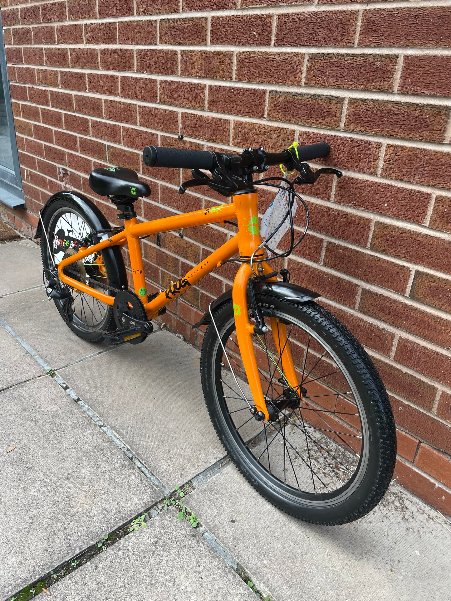 A Pre Loved Frog Bike For Sale, Orange Frog 55, lightweight children’s bicycle, 20” wheels, 8 speed, V brakes, mudguards, nationwide delivery is available.