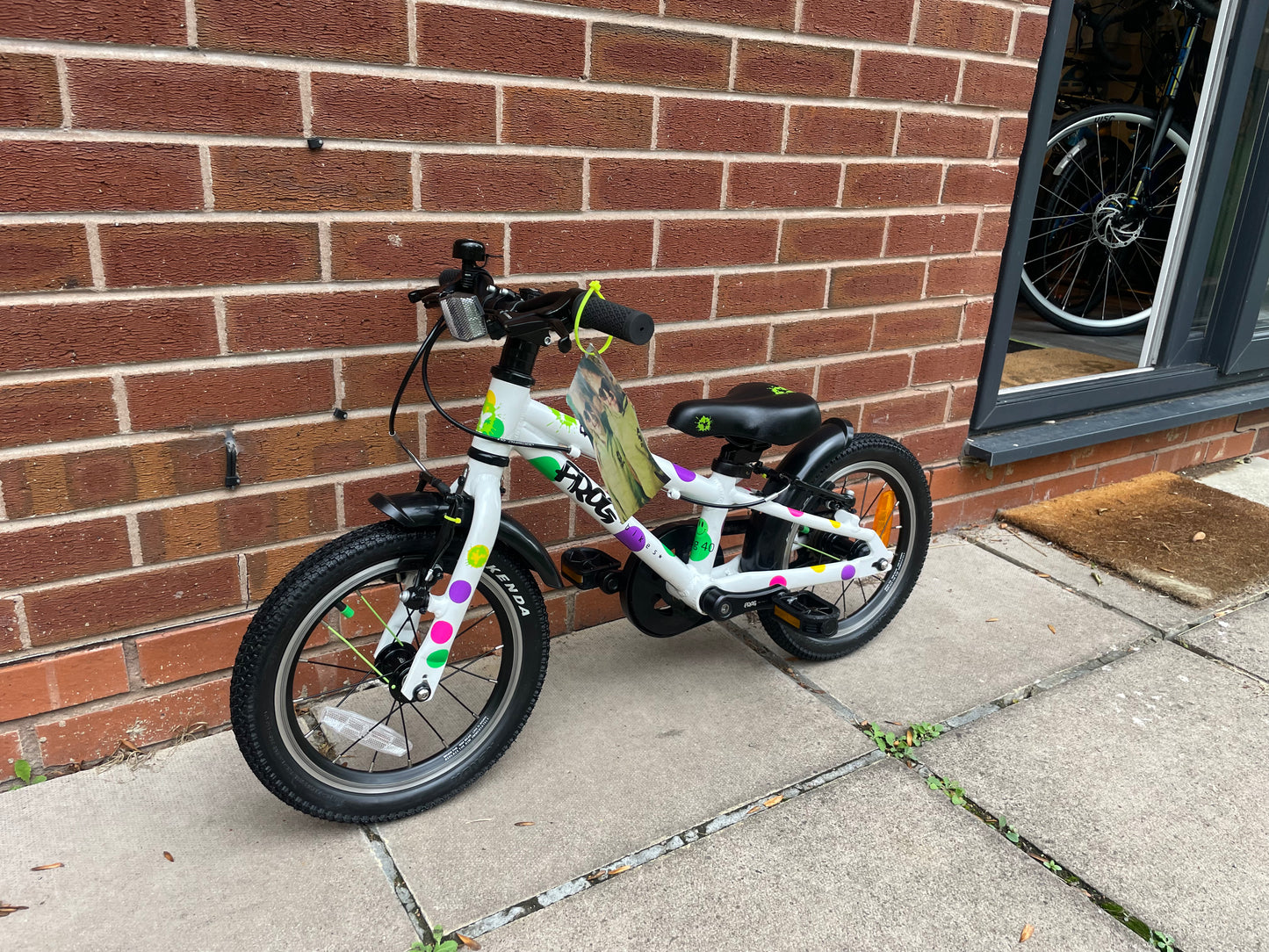 A Pre Loved Frog Bike For Sale, White Spotty Frog 40 first pedal bike, 14” wheels, single speed, padded seat, V brakes, fully enclosed chain, mudguards, nationwide delivery is available.