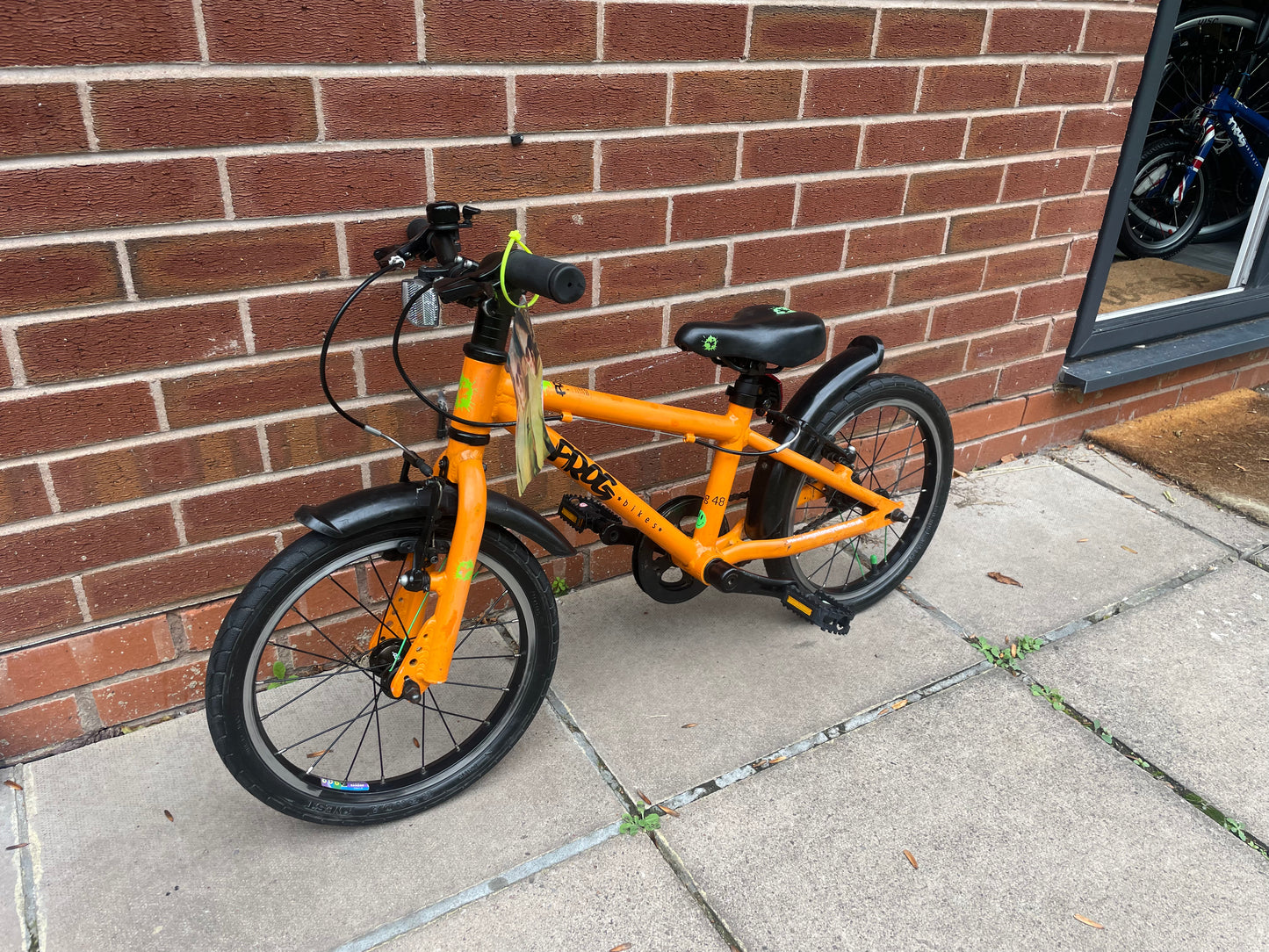 A Pre Loved Frog Bike For Sale, Orange Frog 48 first pedal bike, lightweight, 16” wheels, mudguards, V brakes, nationwide delivery is available.