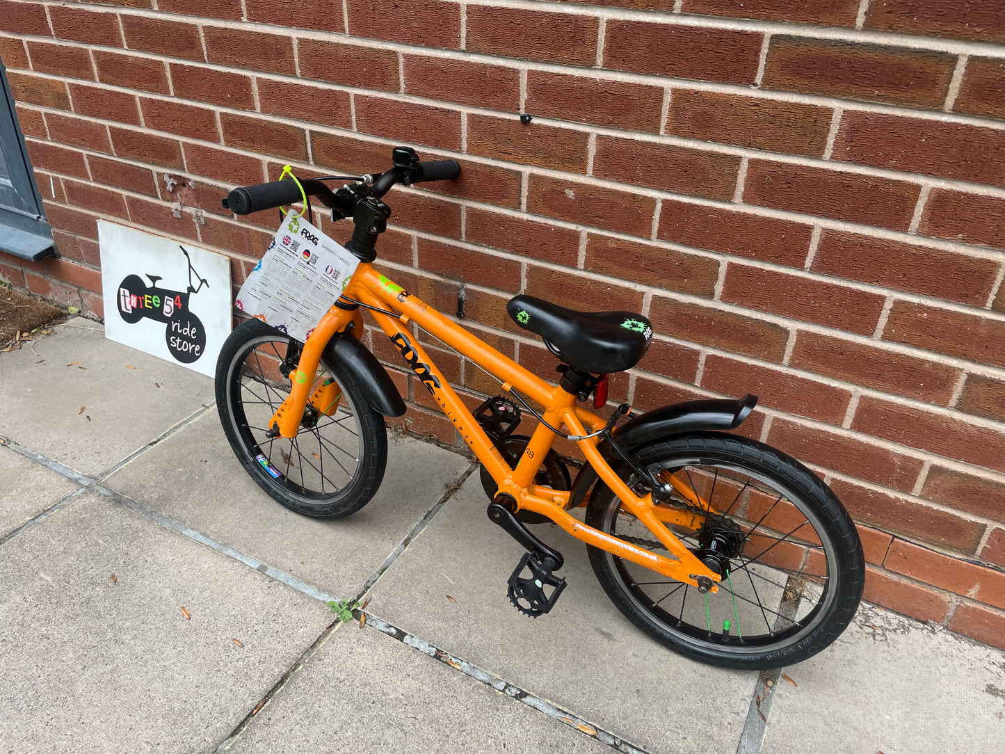 A Pre Loved Frog Bike For Sale, Orange Frog 48 first pedal bike, lightweight, 16” wheels, mudguards, V brakes, nationwide delivery is available.