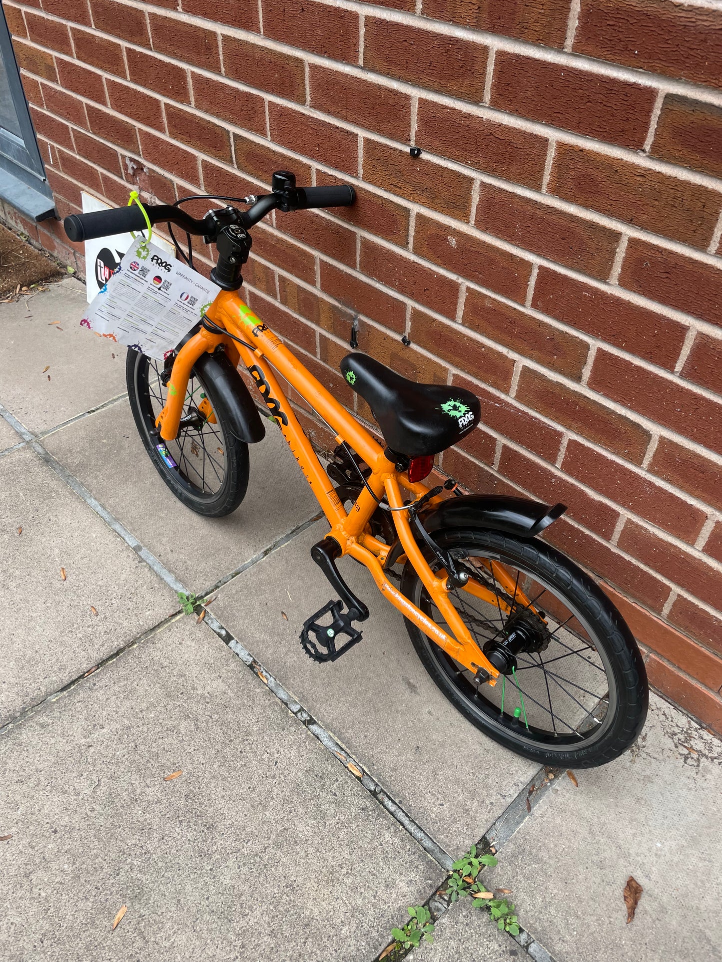 A Pre Loved Frog Bike For Sale, Orange Frog 48 first pedal bike, lightweight, 16” wheels, mudguards, V brakes, nationwide delivery is available.