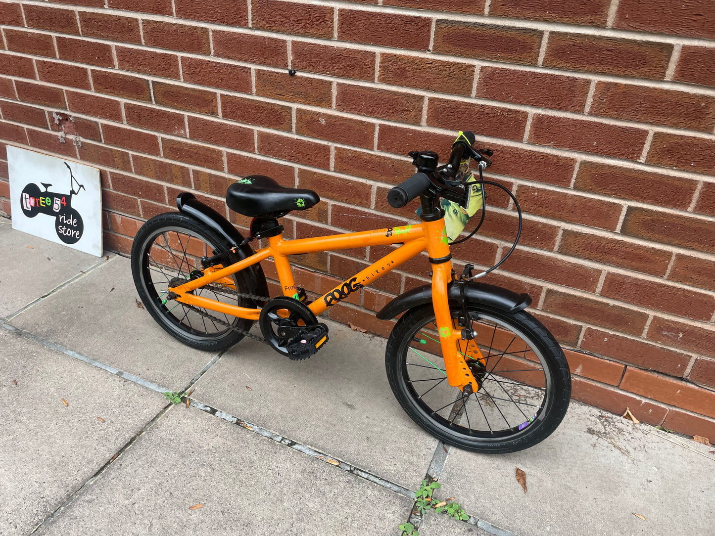 A Pre Loved Frog Bike For Sale, Orange Frog 48 first pedal bike, lightweight, 16” wheels, mudguards, V brakes, nationwide delivery is available.