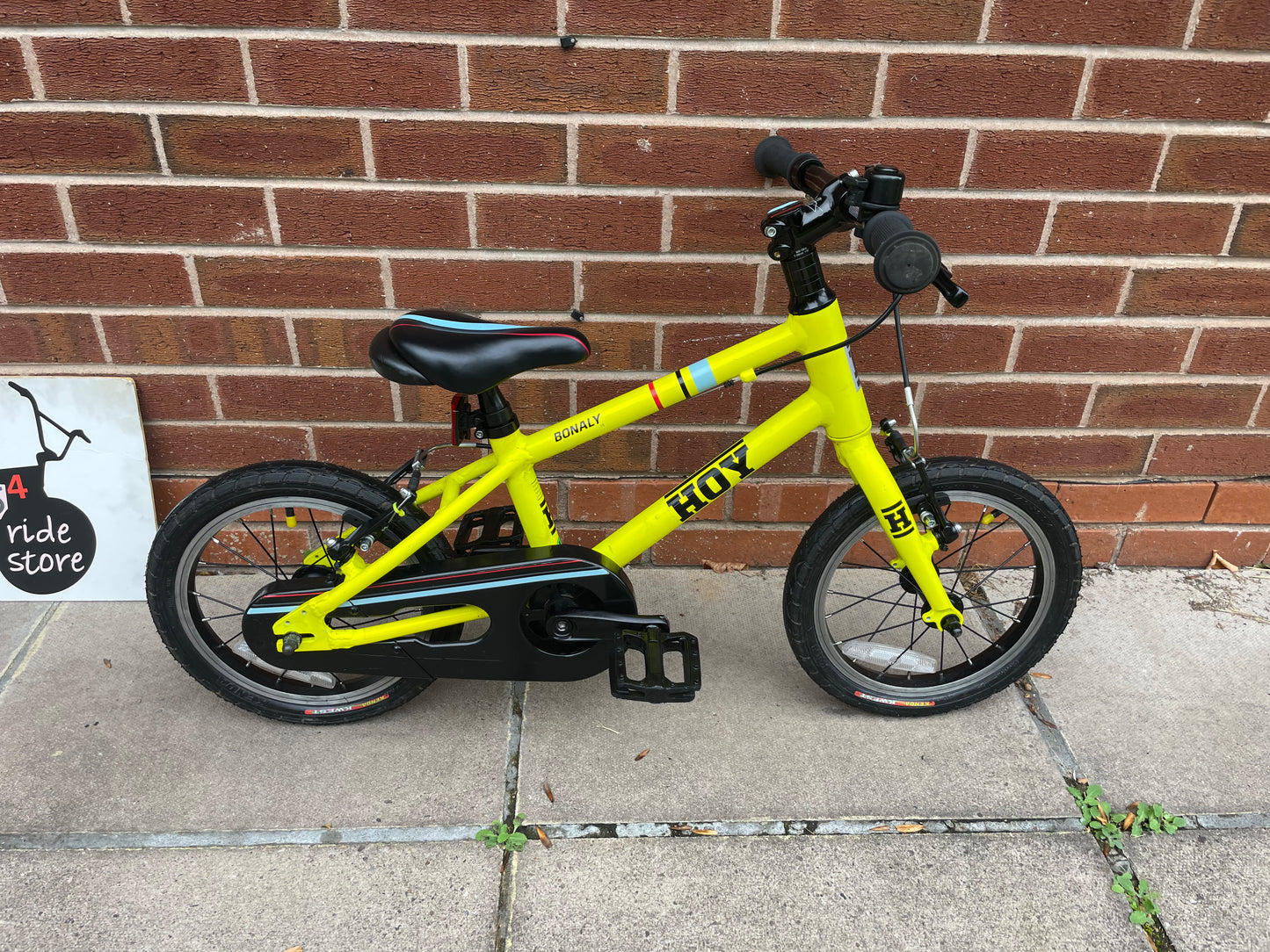 A Pre Loved Hoy Bonaly 14” first pedal bike For Sale, bright yellow, padded seat, V brakes, fully enclosed chain, nationwide delivery is available.