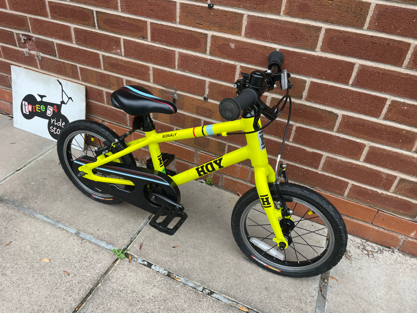 A Pre Loved Hoy Bonaly 14” first pedal bike For Sale, bright yellow, padded seat, V brakes, fully enclosed chain, nationwide delivery is available.