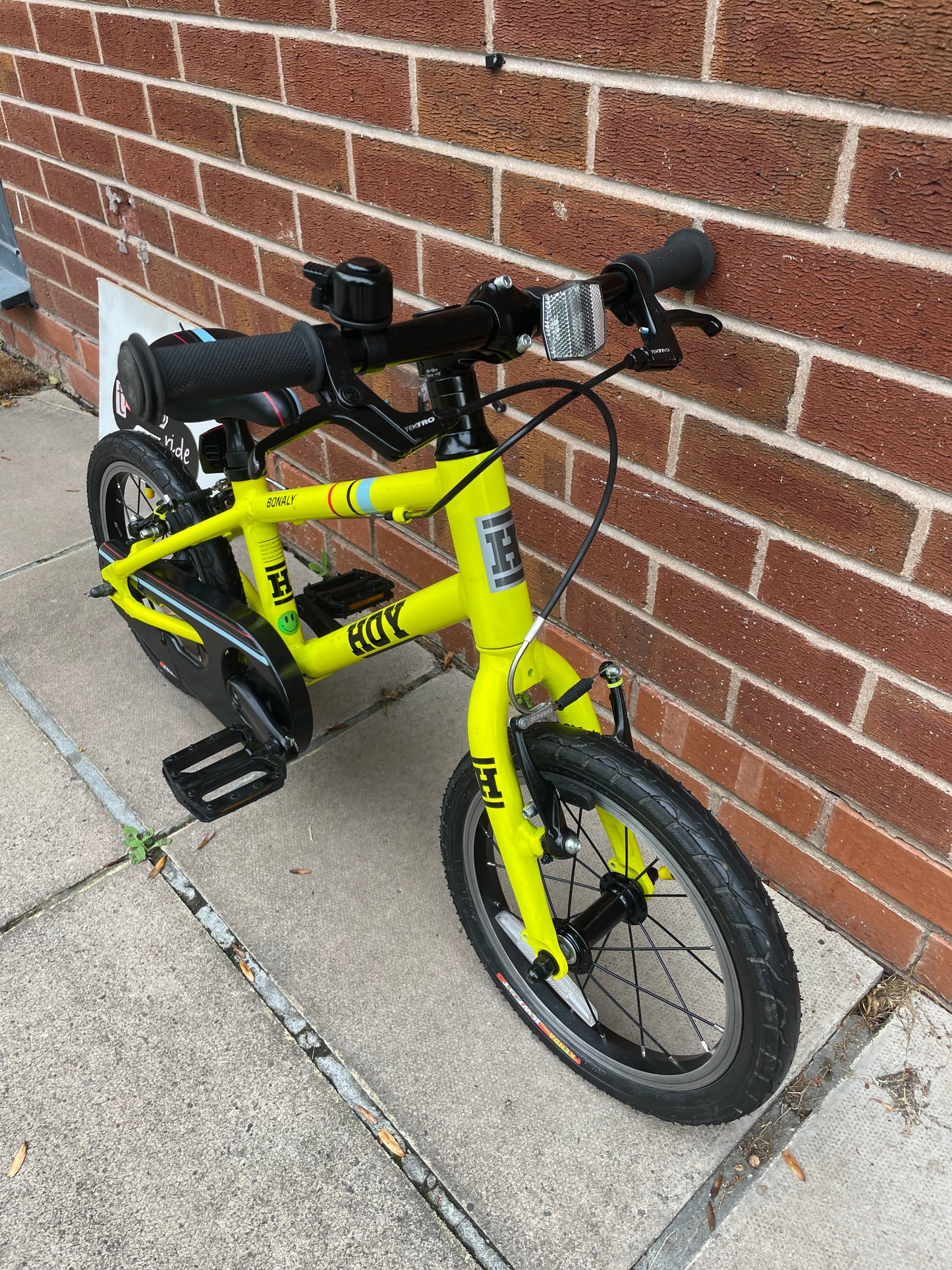 A Pre Loved Hoy Bonaly 14” first pedal bike For Sale, bright yellow, padded seat, V brakes, fully enclosed chain, nationwide delivery is available.