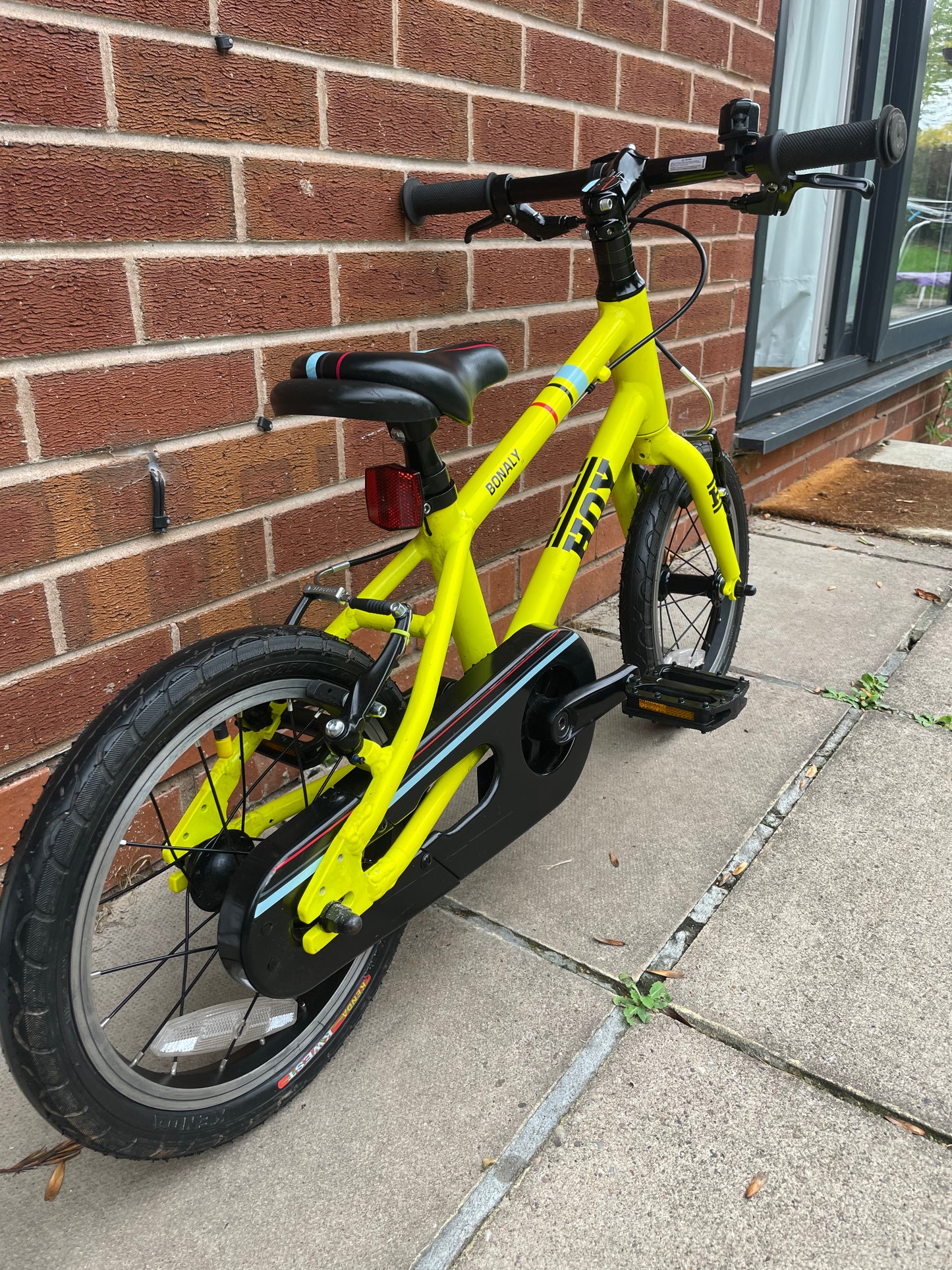 A Pre Loved Hoy Bonaly 14” first pedal bike For Sale, bright yellow, padded seat, V brakes, fully enclosed chain, nationwide delivery is available.