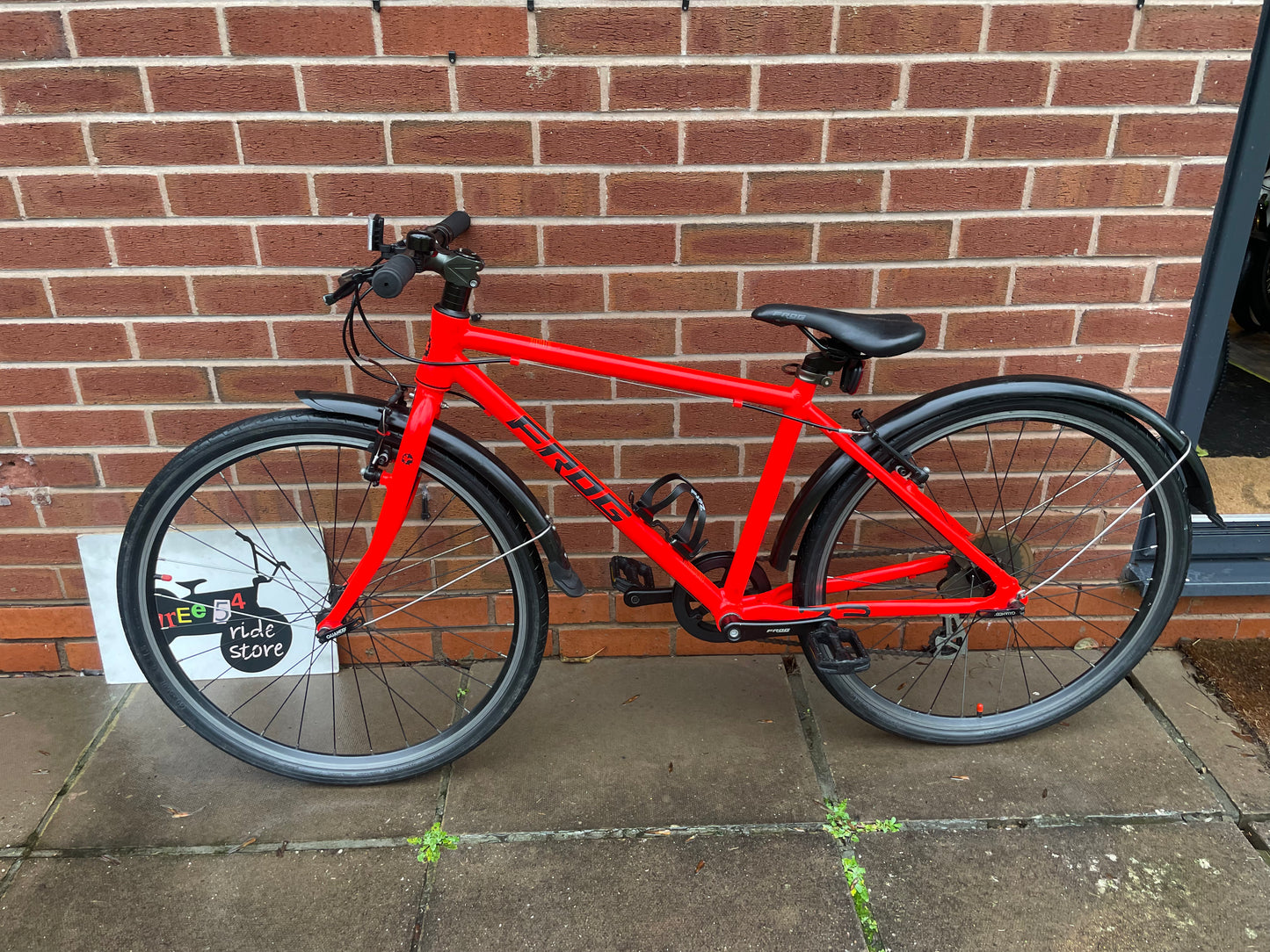 A Pre Loved Frog Bike For Sale Neon Red Frog 73, 26” wheels, 8 speed, V brakes, mudguards, bottle cage, very lightweight, nationwide delivery is available.