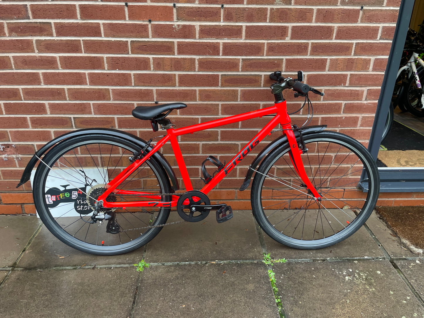 A Pre Loved Frog Bike For Sale Neon Red Frog 73, 26” wheels, 8 speed, V brakes, mudguards, bottle cage, very lightweight, nationwide delivery is available.