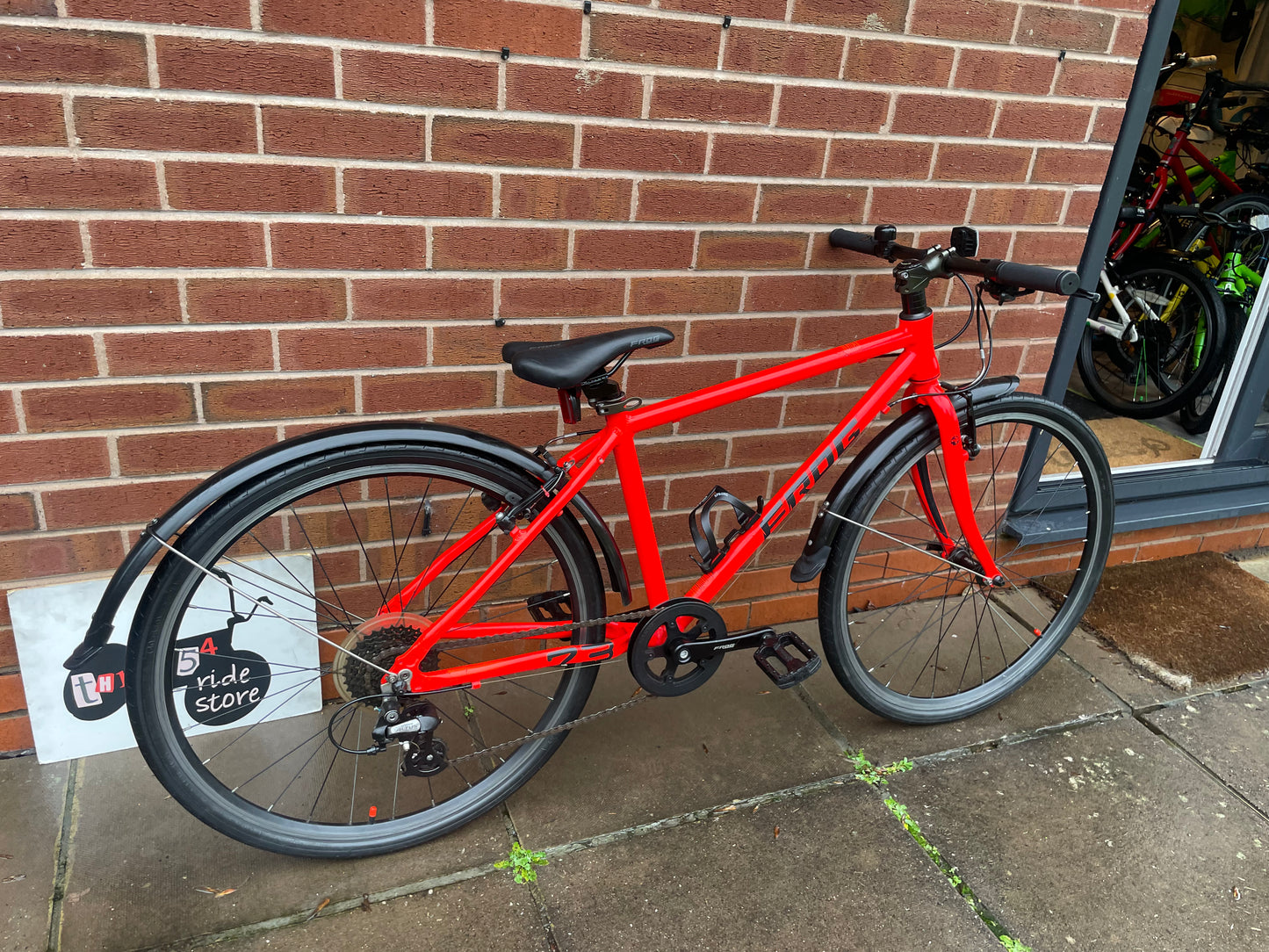 A Pre Loved Frog Bike For Sale Neon Red Frog 73, 26” wheels, 8 speed, V brakes, mudguards, bottle cage, very lightweight, nationwide delivery is available.