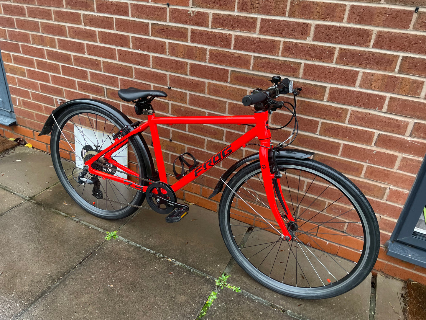 A Pre Loved Frog Bike For Sale Neon Red Frog 73, 26” wheels, 8 speed, V brakes, mudguards, bottle cage, very lightweight, nationwide delivery is available.